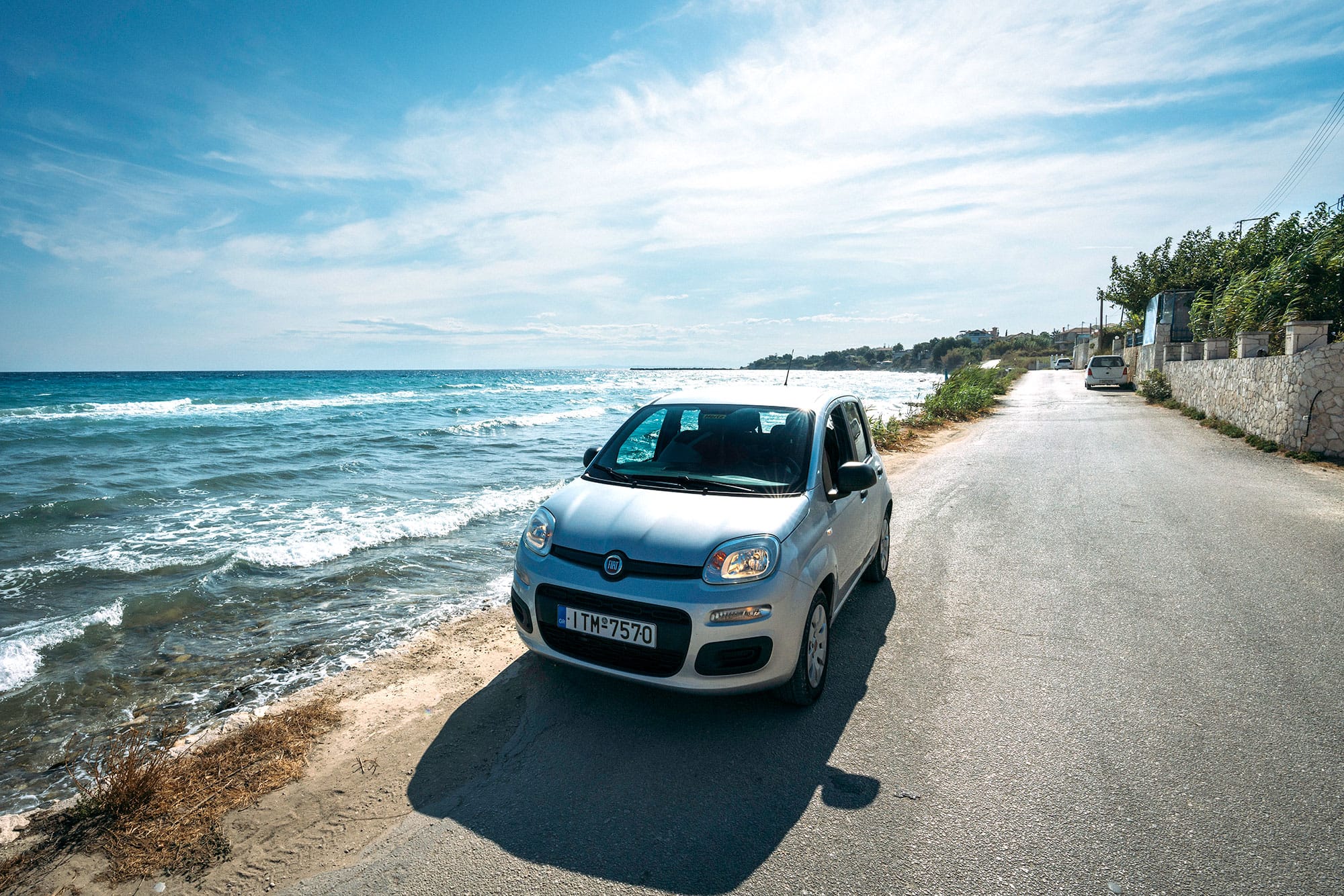 Economy rental car ready for a Santorini road trip