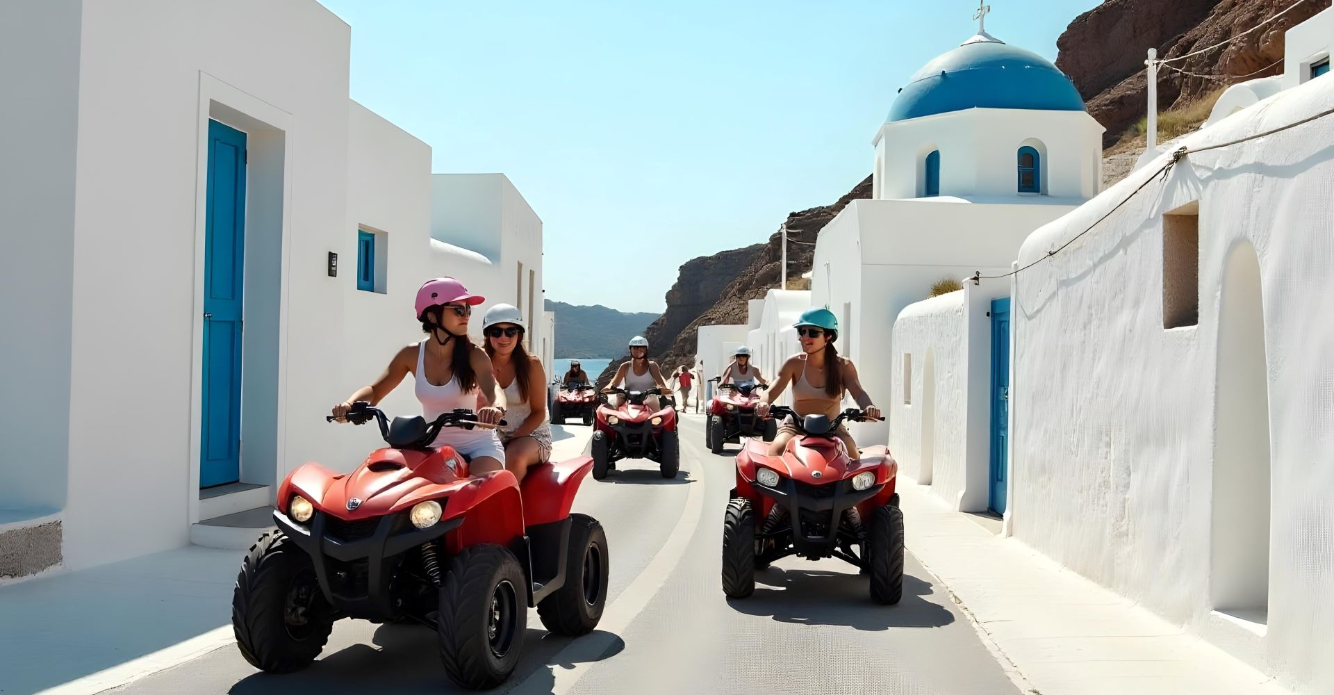 A couple driving a rental buggy along the coast of Santorini